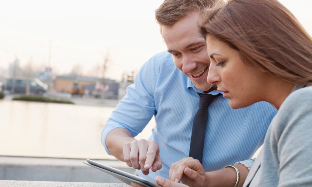 Business people using tablet computer --- Image by © Frank van Delft/cultura/Corbis